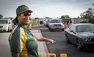 Peoria security guard directs traffic and smiles at camera